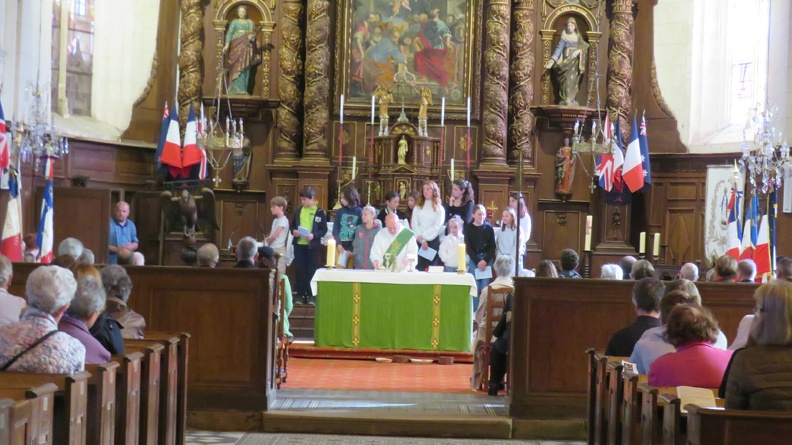 A view of the parishoner , server and children at thwe beautiful altar